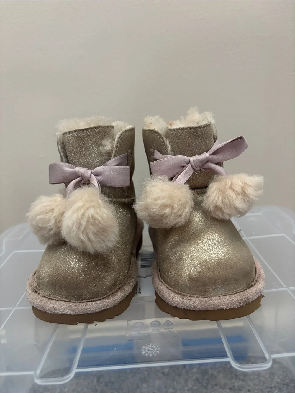 UGG Kids Metallic Gold Pom-Pom Boots with Pink Ribbon